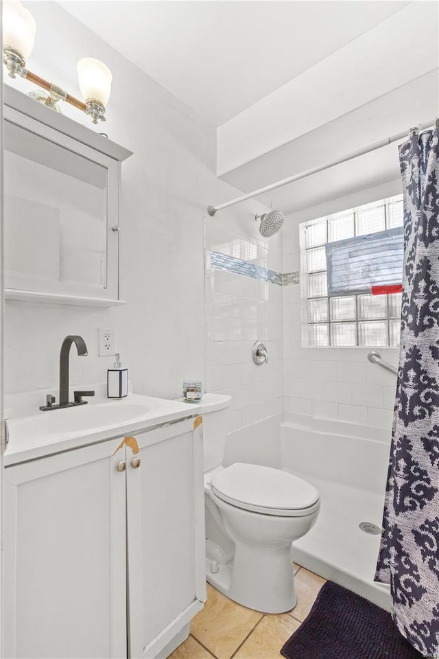 bathroom featuring tile patterned floors, curtained shower, vanity, and toilet