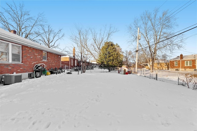 yard covered in snow with cooling unit