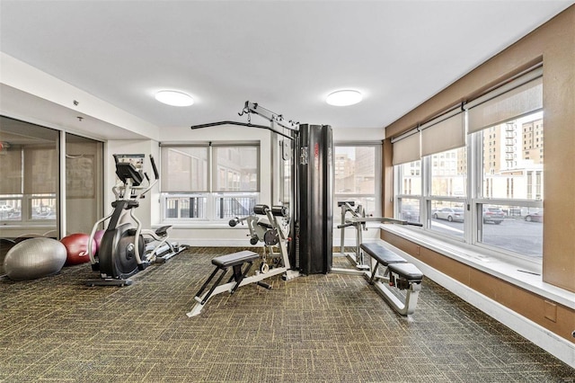 gym with dark carpet and a wealth of natural light