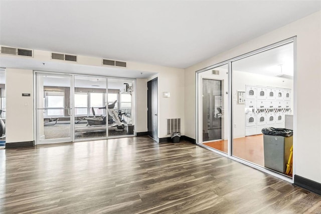 exercise room with dark hardwood / wood-style flooring