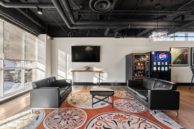 living room with hardwood / wood-style flooring and a towering ceiling