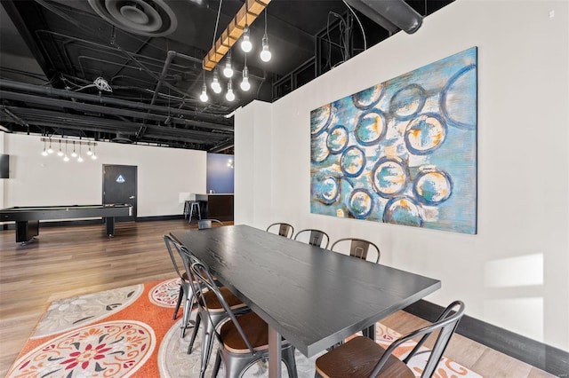 dining space with hardwood / wood-style flooring and pool table