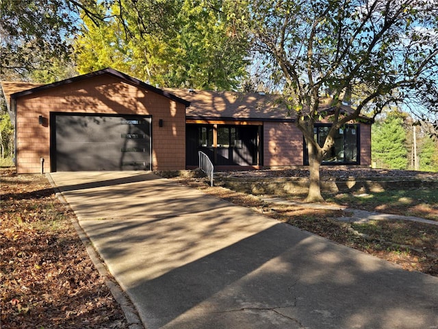 view of front of home featuring an attached garage and concrete driveway