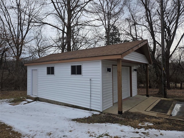 snow covered structure featuring an outdoor structure