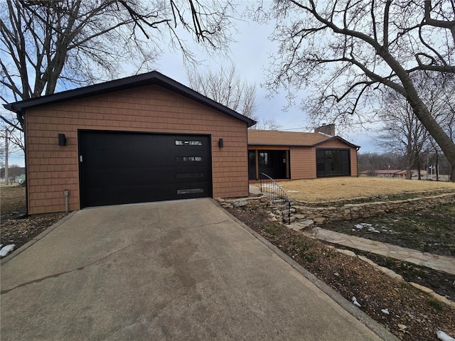 ranch-style home with driveway and a chimney