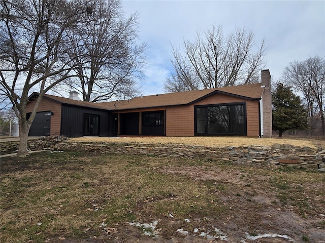 view of front of house with a garage and a chimney