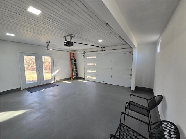 garage featuring a garage door opener, french doors, and baseboards