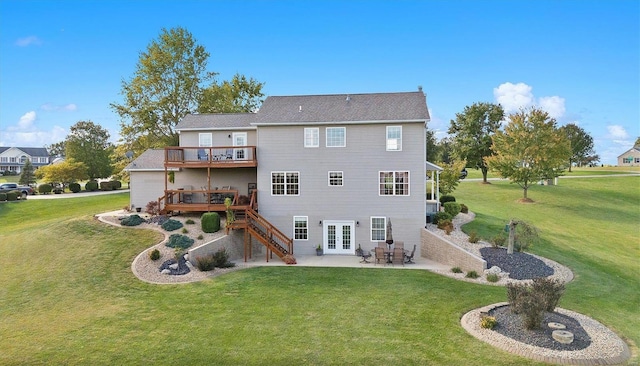 back of property with a wooden deck, a yard, and a patio