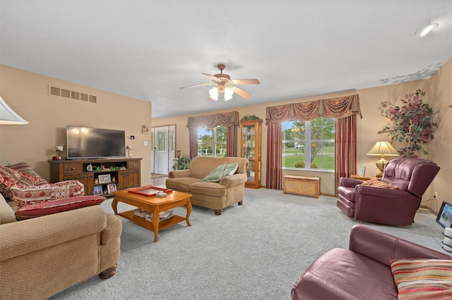 carpeted living room featuring ceiling fan