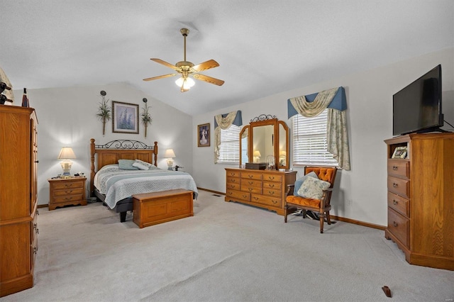 carpeted bedroom with lofted ceiling and ceiling fan