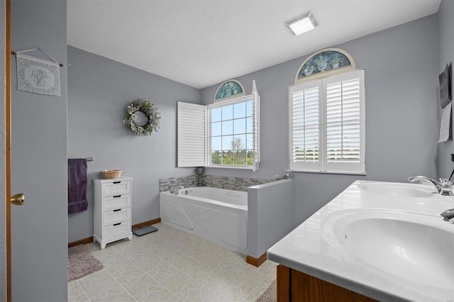 bathroom featuring vanity and a tub