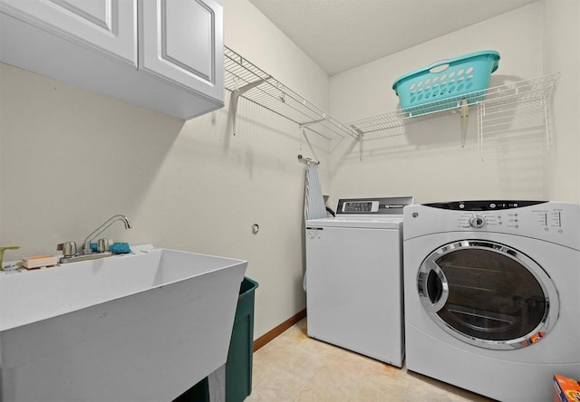 washroom with washer and dryer, sink, and cabinets