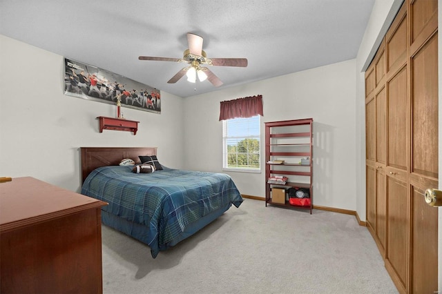 bedroom with ceiling fan and light carpet