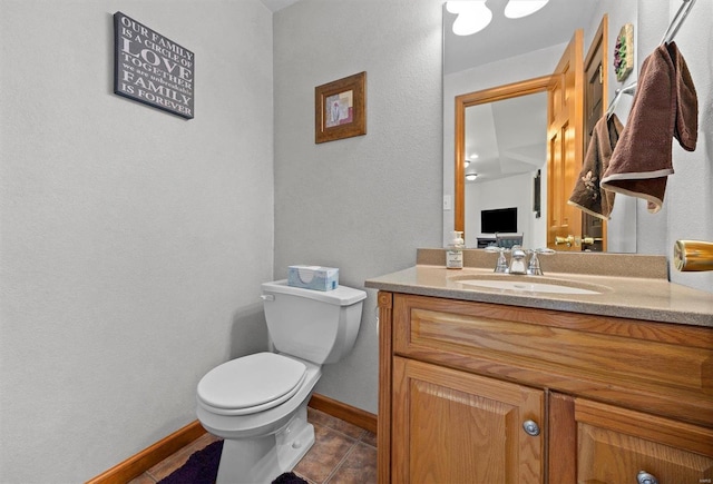 bathroom with vanity, tile patterned flooring, and toilet