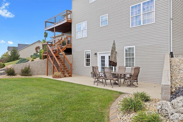 back of house featuring french doors, a patio area, and a lawn