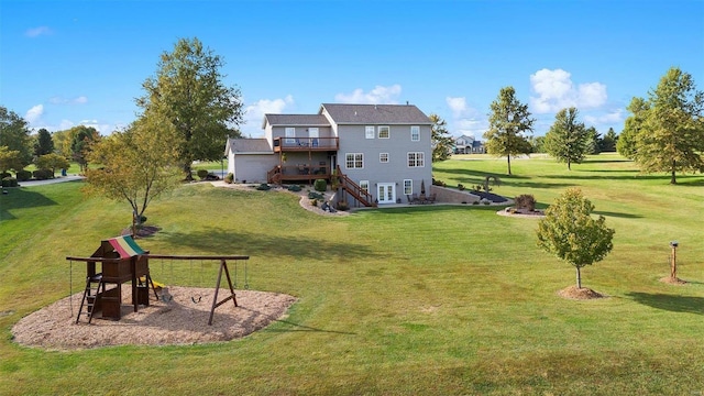 back of property with a wooden deck, a yard, and a playground