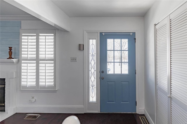 entryway with a brick fireplace