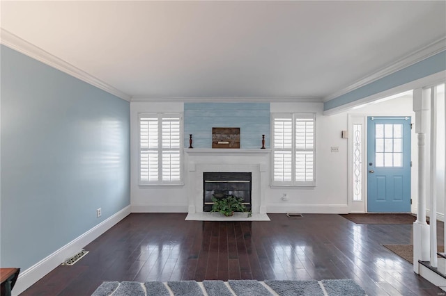 unfurnished living room featuring ornamental molding, dark hardwood / wood-style floors, and a large fireplace