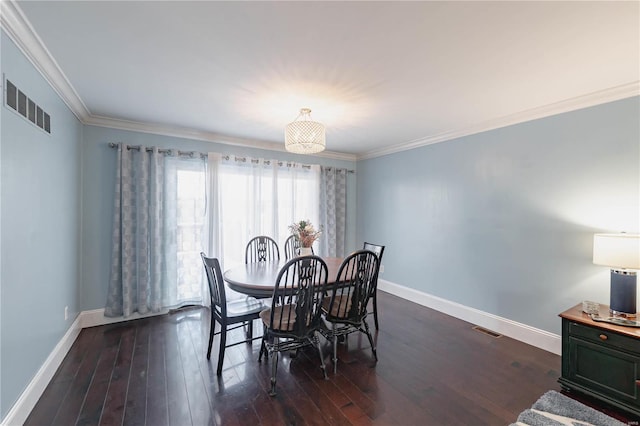 dining area featuring dark hardwood / wood-style flooring and crown molding