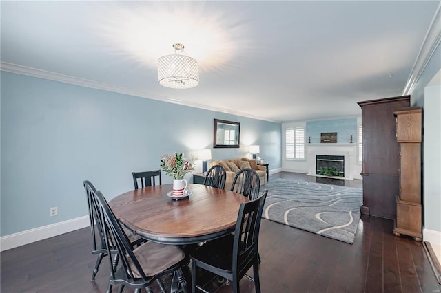 dining space featuring dark wood-type flooring and crown molding