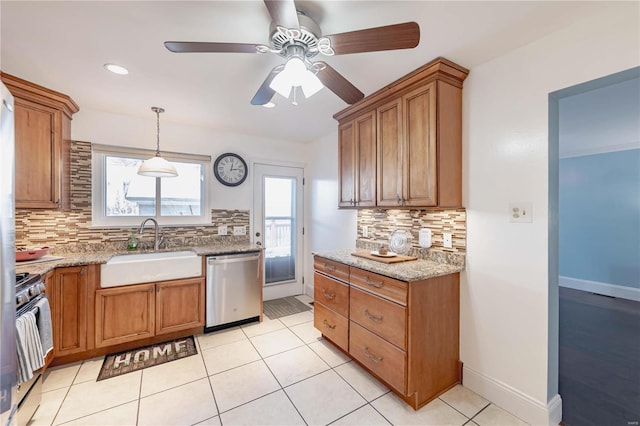 kitchen featuring stainless steel appliances, sink, decorative light fixtures, ceiling fan, and tasteful backsplash