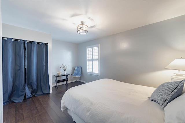 bedroom with dark hardwood / wood-style flooring