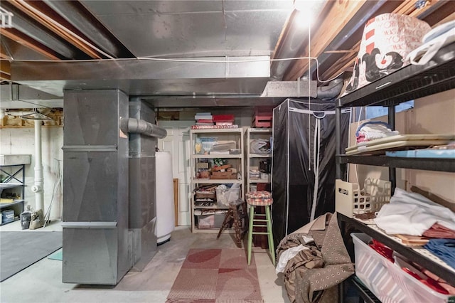 basement featuring water heater and heating unit