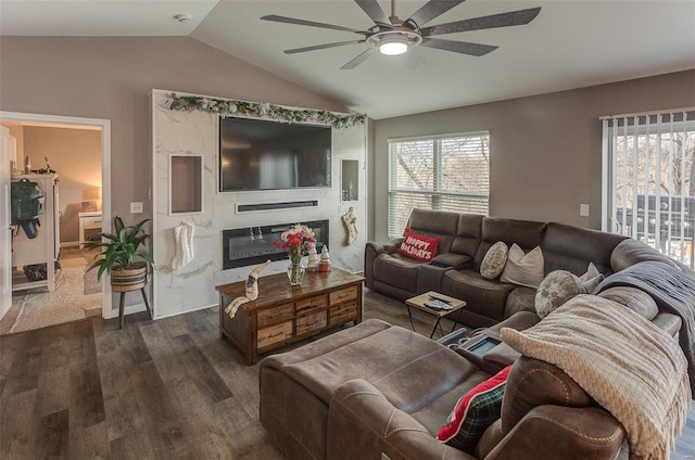 living room featuring ceiling fan, dark wood-type flooring, and lofted ceiling