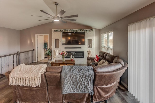 living room with ceiling fan, dark hardwood / wood-style flooring, and vaulted ceiling