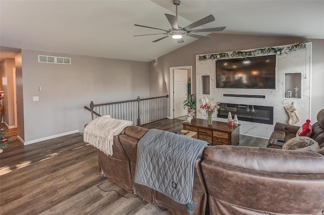 living room with dark hardwood / wood-style floors, ceiling fan, and lofted ceiling