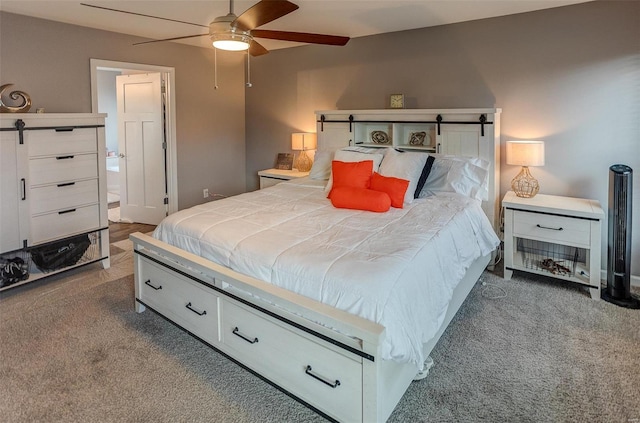 carpeted bedroom featuring connected bathroom and ceiling fan