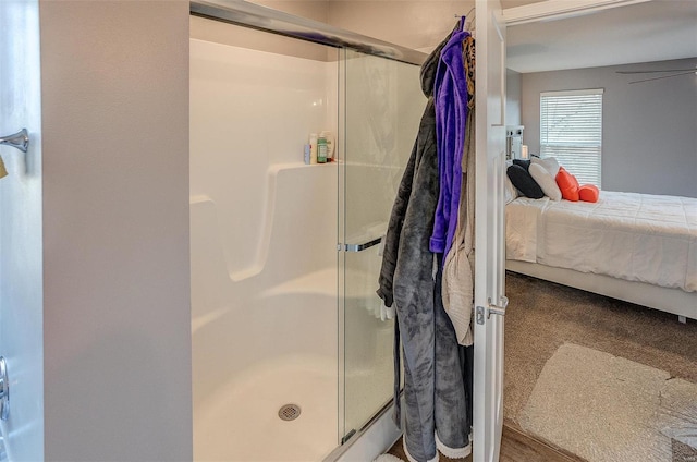 bathroom featuring an enclosed shower and ceiling fan