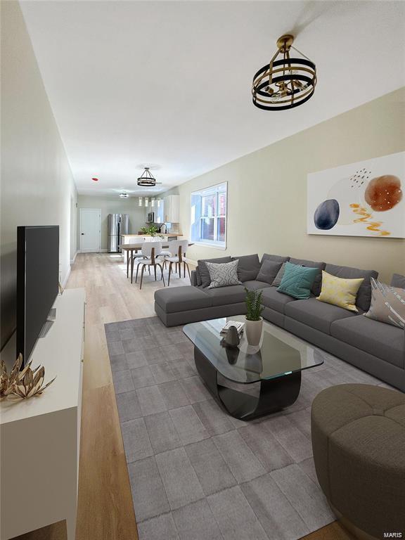 living room featuring a chandelier and light wood-type flooring