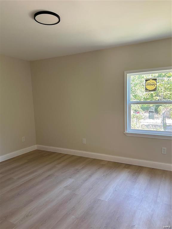 unfurnished room featuring light hardwood / wood-style flooring