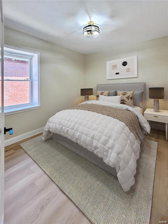 bedroom featuring baseboards and wood finished floors