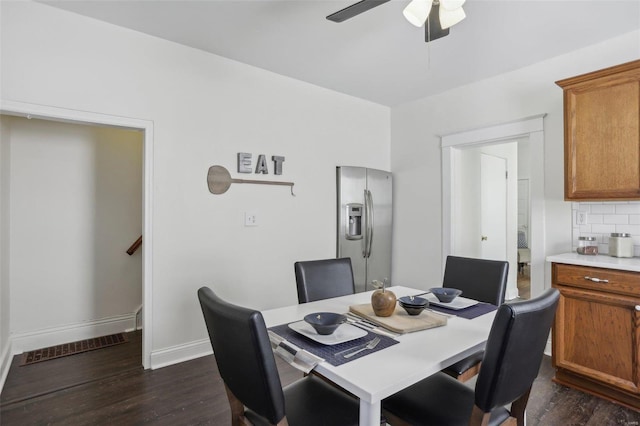 dining area with dark hardwood / wood-style floors and ceiling fan