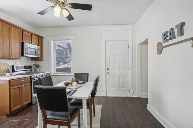 dining space featuring ceiling fan and dark wood-type flooring