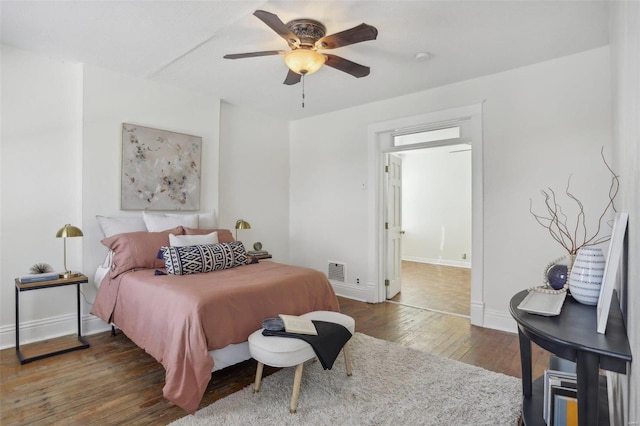 bedroom with ceiling fan and dark wood-type flooring