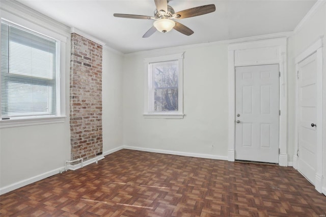 unfurnished room featuring ceiling fan, dark parquet flooring, and crown molding