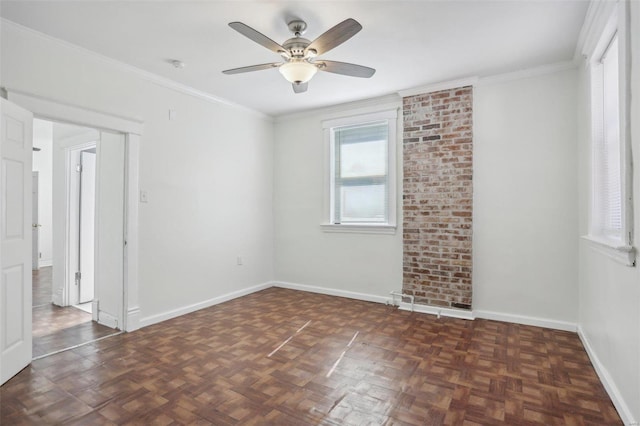 spare room featuring dark parquet floors, ceiling fan, and ornamental molding