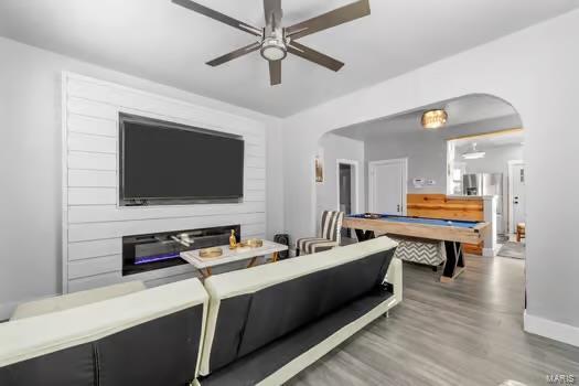 living room with ceiling fan, hardwood / wood-style flooring, and billiards