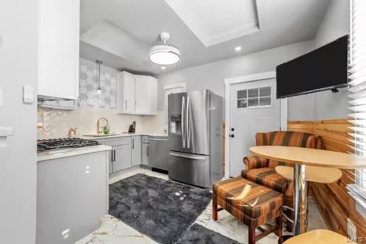 kitchen with white cabinets, sink, and stainless steel appliances