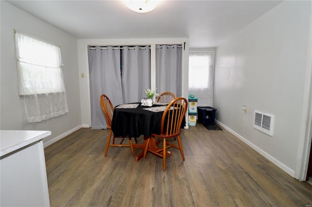 dining room with dark wood-type flooring