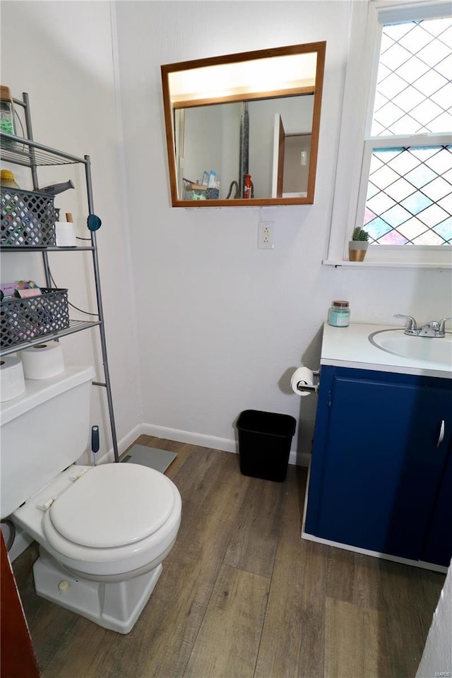 bathroom featuring toilet, hardwood / wood-style flooring, and vanity