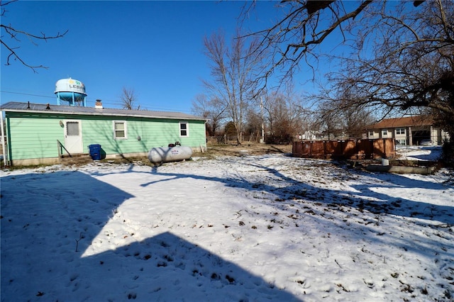 view of snow covered rear of property