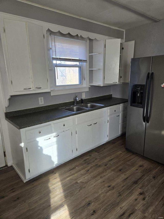 kitchen featuring white cabinetry, sink, dark wood-type flooring, and stainless steel fridge