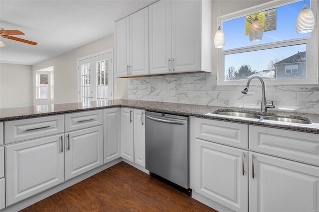 kitchen featuring sink, white cabinets, and dishwasher