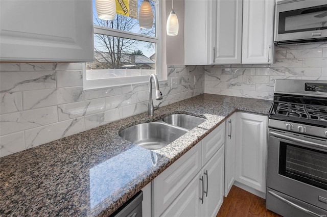 kitchen with sink, white cabinets, and appliances with stainless steel finishes