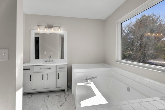 bathroom featuring plenty of natural light, a bathing tub, and vanity