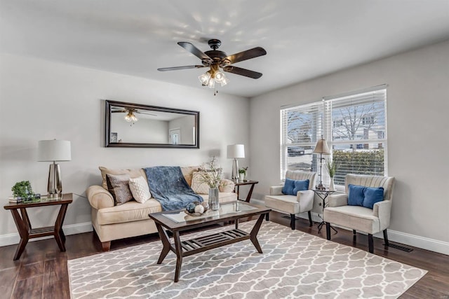 living room featuring ceiling fan and dark hardwood / wood-style floors